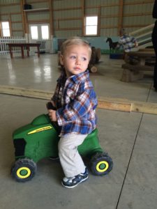 Child riding toy tractor